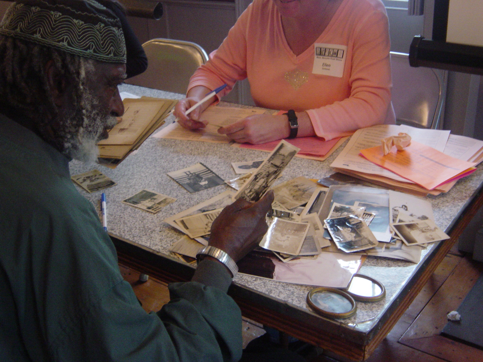 <p>A Volunteer helps Contributor decide which Items to contribute at the Dorchester Mass. Memories Road Show, 2006</p>